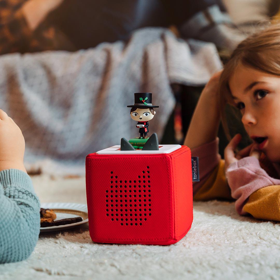 a toy sitting on top of a red ottoman