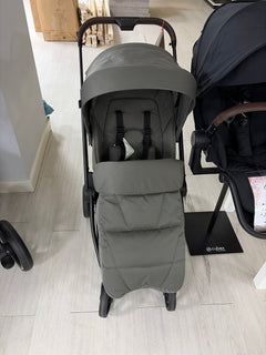 Sage green stroller with padded seat and hood, front view