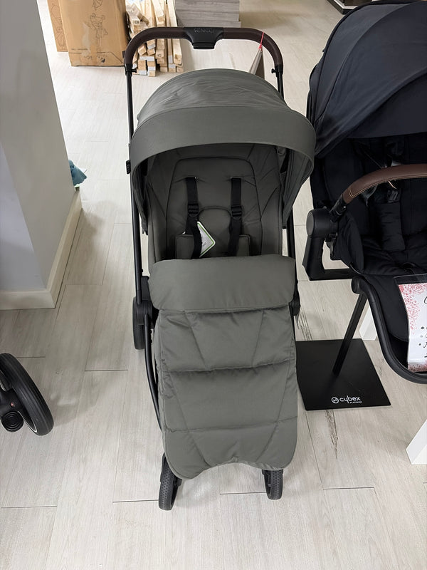 Sage green stroller with padded seat and hood, front view