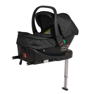Black infant car seat with canopy and green handle, front view on base with stand