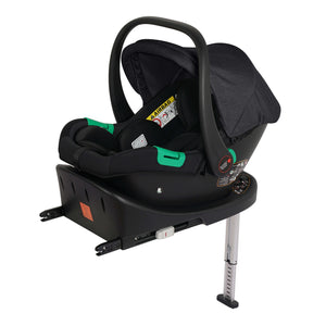 Black infant car seat with canopy and green handle, shown on a matching base