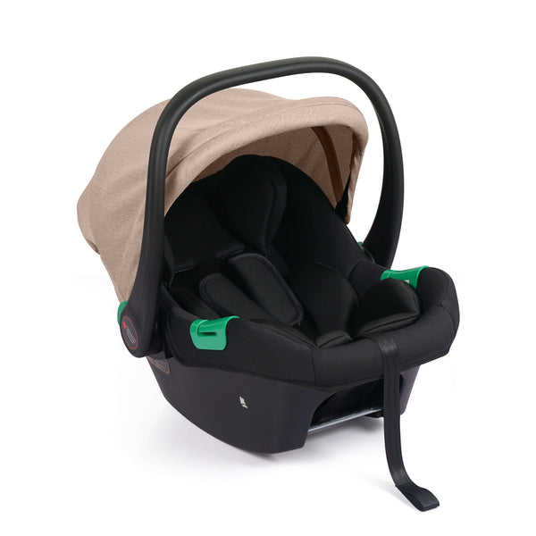 Black infant car seat with beige canopy and green carry handle