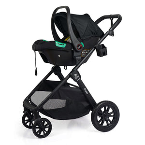 Black stroller with attached infant car seat, canopy up, green handle accents