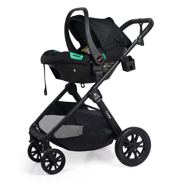 Black stroller with attached infant car seat, canopy up, green handle accents
