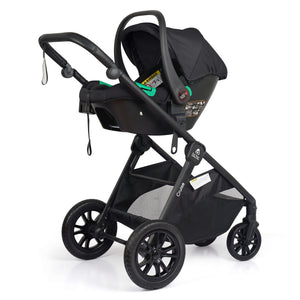 3-wheel black stroller with black infant car seat attached and green handle accents
