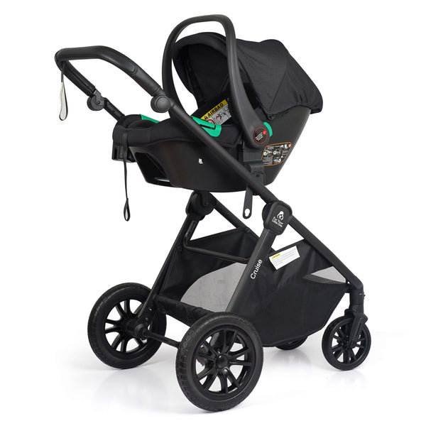 3-wheel black stroller with black infant car seat attached and green handle accents