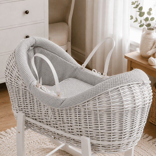 Grey wicker baby Moses basket with white stand and padded pod liner