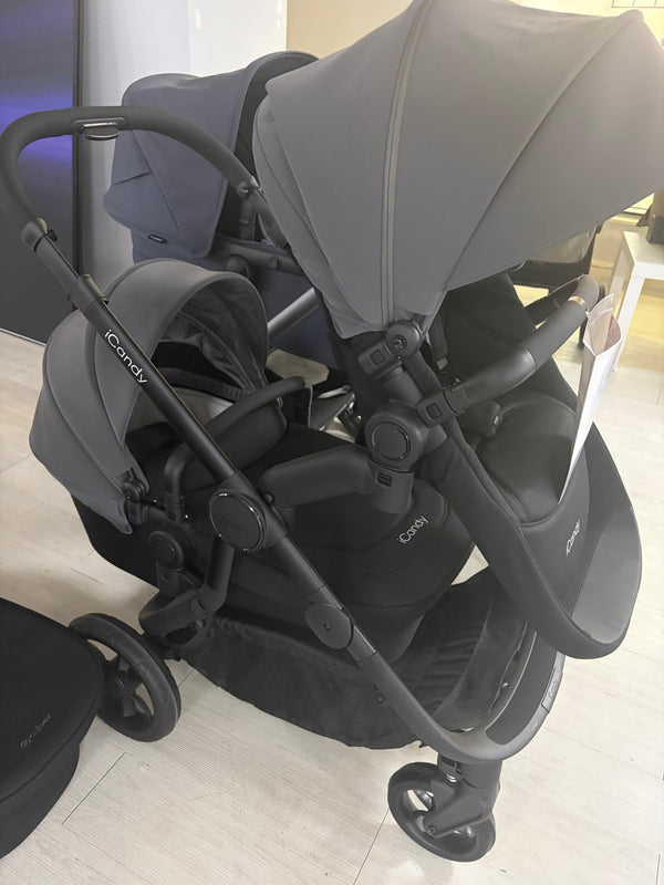 Grey pushchair with carrycot and padded seat, side view, adjustable handle and wheels