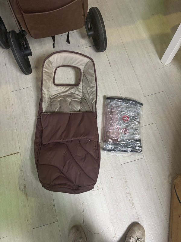 Burgundy pram footmuff with light insert cover, shown from above