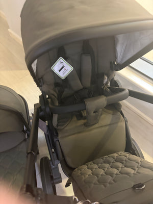 Moss stroller seat with canopy and quilted footmuff, front view