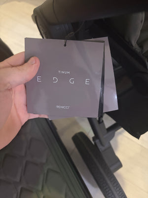 Venicci Tinum Edge shopping bag held near a moss stroller frame
