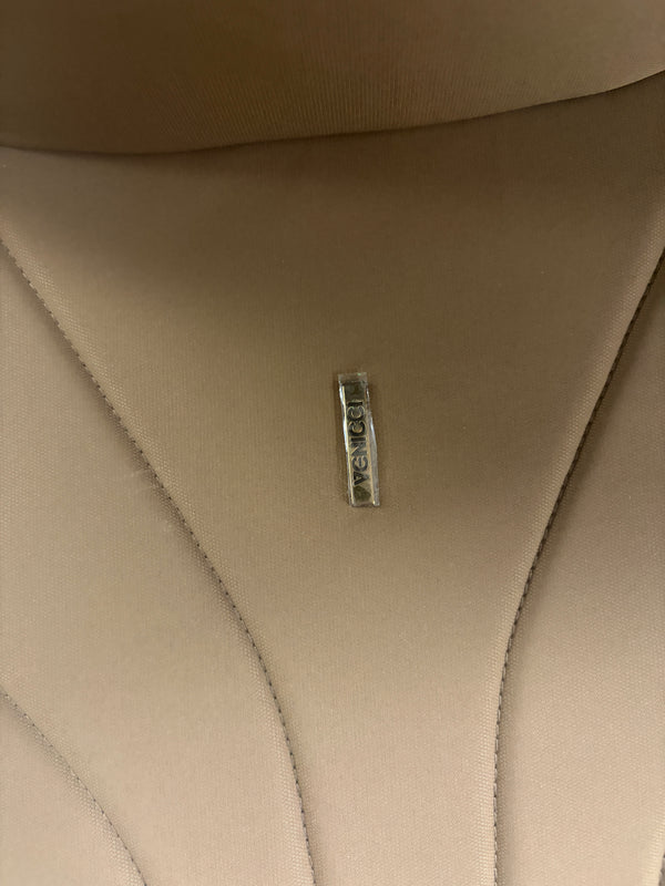 Venicci Claro carrycot fabric close-up with logo tag on tan upholstery