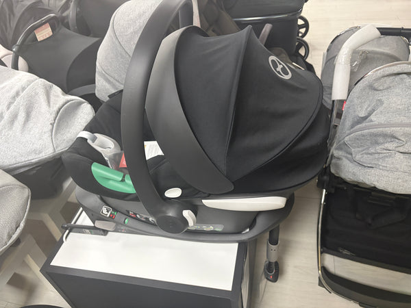 Black Cybex infant car seat with ISOFIX base, side view