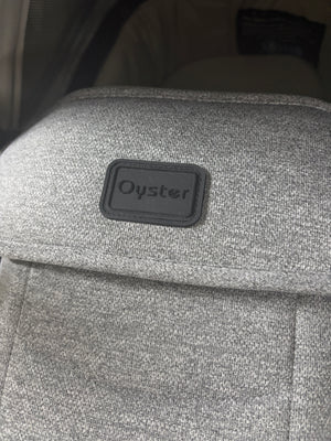 Oyster label on grey carrycot fabric cover