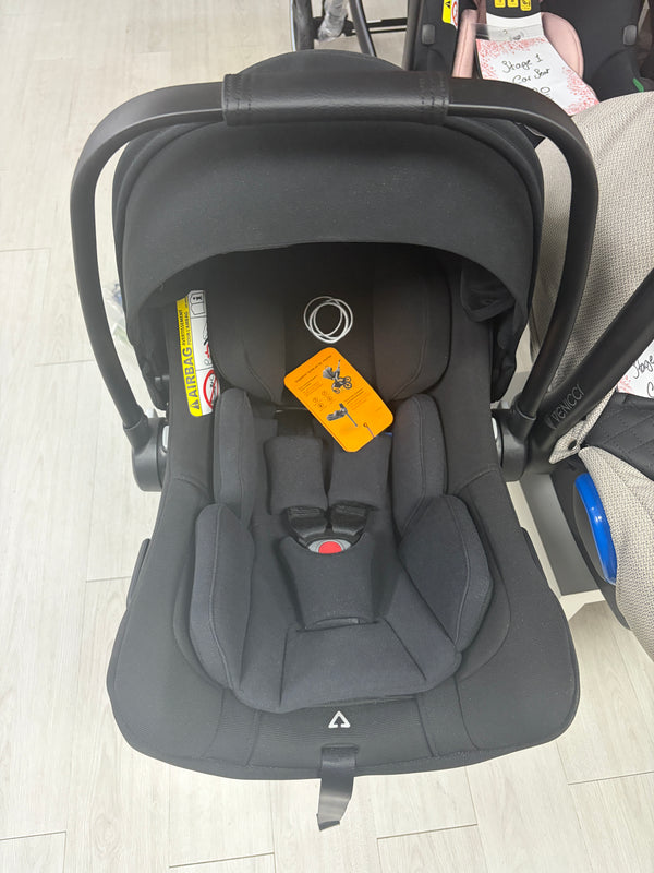 Black baby car seat with canopy, padded harness, and recline base