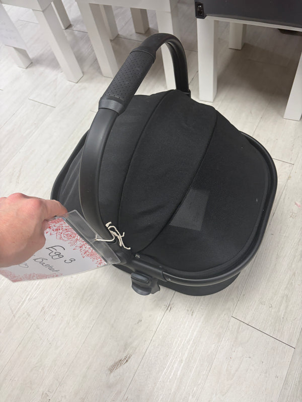 Dark gray pet stroller carrier with fold-up hood and front handle, no wheels visible
