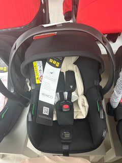 Newborn car seat with beige padded insert, black shell, safety harness, front view