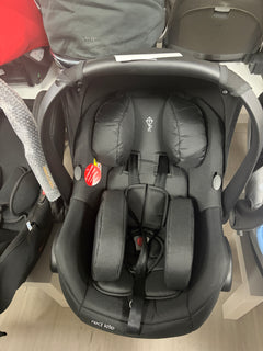 Red Kite newborn car seat with black padded inserts and 5-point harness, front view