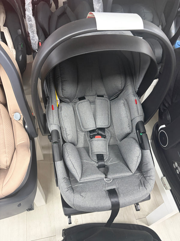 Grey newborn car seat with padded harness, head support, on ISOFIX base