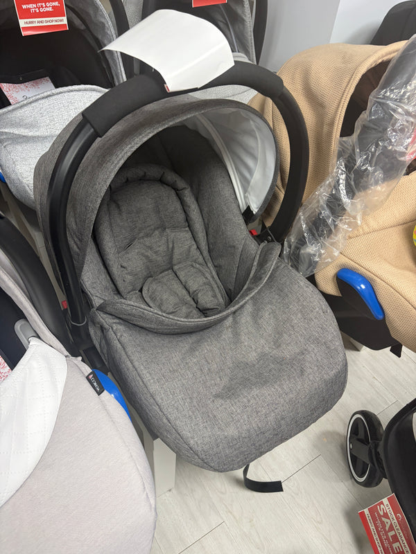 Newborn car seat with gray fabric hood and padded insert, side view