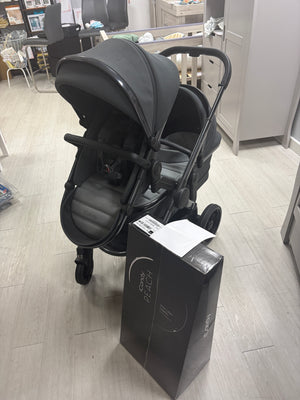 Dark gray tandem stroller with two seat units and carrycot