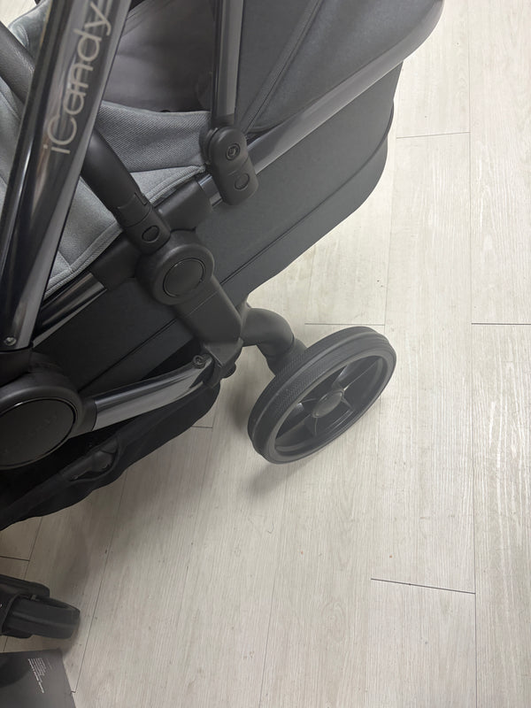 Dark gray tandem stroller wheel and side frame detail