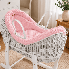 Pink wicker baby Moses basket with white stand and padded pod liner