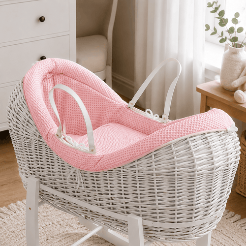 Pink wicker baby Moses basket with white stand and padded pod liner
