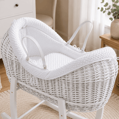 White wicker baby Moses basket with white stand and textured padded pod liner