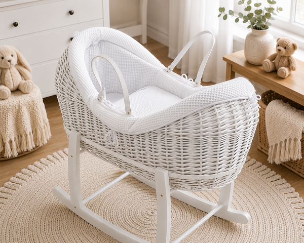 White wicker baby crib in a nursery with toys and decor.
