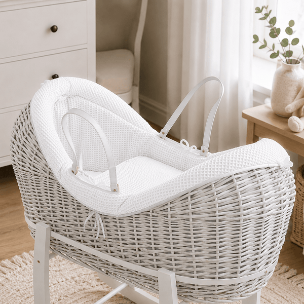 White wicker baby Moses basket with white stand and padded pod liner