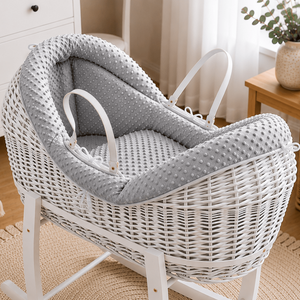 White wicker rocking chair with gray cushion in a nursery setting