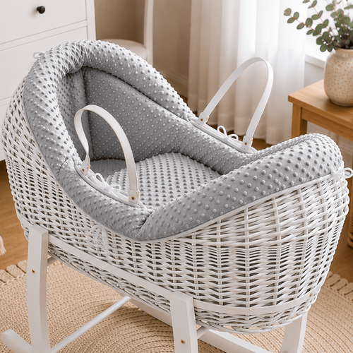 White wicker rocking chair with gray cushion in a nursery setting